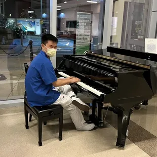a man in a mask playing a piano