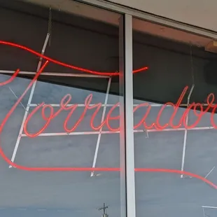 a neon sign in the window