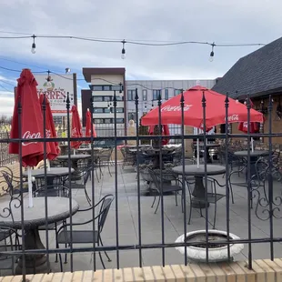 a patio with tables and umbrellas