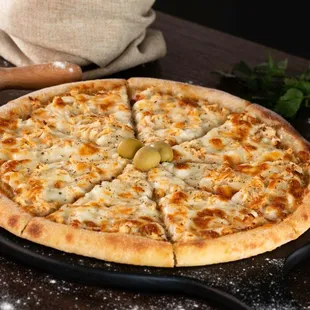 a pizza with olives and cheese