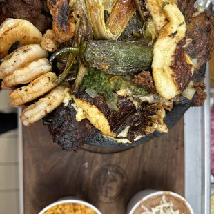A molcajete with its side of rice and beans. It also comes with your choice of flour or corn tortillas.