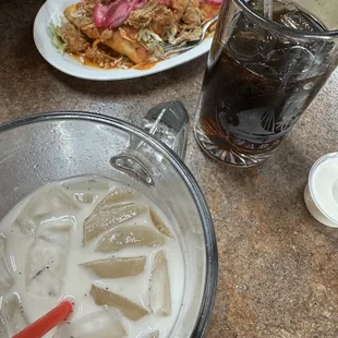 Horchata and coke &amp; another plate of the hard tacos topped with carnitas in the back