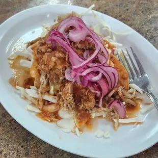 Tacos dorados topped with carnitas, cabbage, pickled onions, &amp; sauce. I got one with beans &amp; one with requeson.