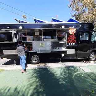 a man standing in front of a food truck