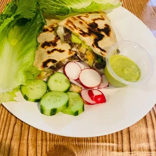a tortilla with lettuce and radishes