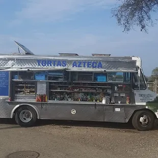 a woman standing in front of a food truck