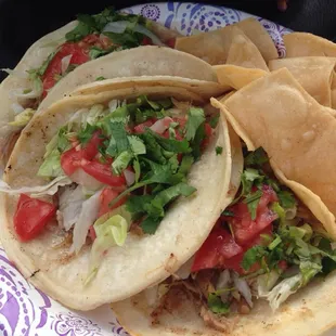 Carnita tacos+ cilantro, lettuce and tomatoes
