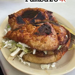 "Pambazo". I recommend it! The bread is soaked in a chile sauce then pan fried. It adds a Smokey, savory flavor to the sandwich.