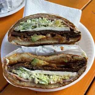Torta michoacana- has onions, tomatoes, carne milanesa (breaded steak), cheese, lettuce, ham