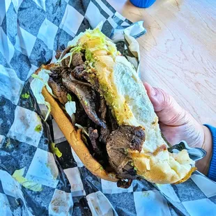 a hand holding a sandwich