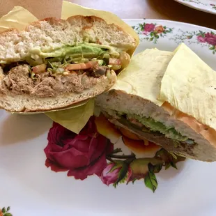 Desehebrada con Rajas Torta: Shredded Green Chili Beef, Lettuce, Tomato, Avocado, Mayonnaise on a Bolillo Roll.