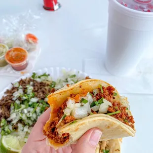 a hand holding a taco