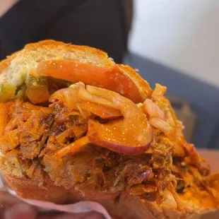 a person holding a sandwich