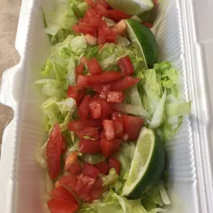 Lettuce, tomato, limes to eat with flautas, tacos, enchiladas, gorditas