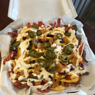 Loca Fríes (Hot Cheetos, fries, sour cream, jalapeños, salsa, cilantro, etc)