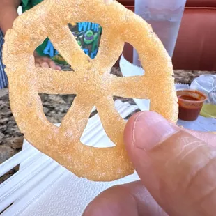 a hand holding a pretzel