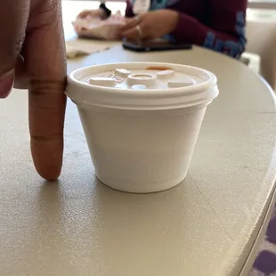 a hand holding a cup of coffee