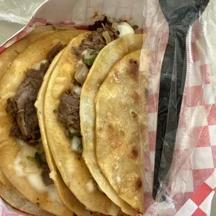 Birria tacos, about the size of a spoon handle.