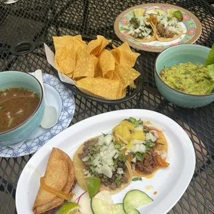 Guac and chips, tacos, consome