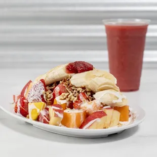Biónico (fruit salad with granola pecan nuts and our signature sweet crema) with a Strawberry smoothie