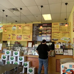a man standing in front of a menu
