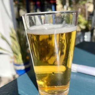 a glass of beer on a table