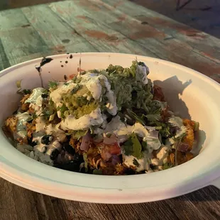 a bowl of food on a wooden table