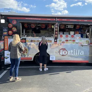 two women ordering food from a food truck