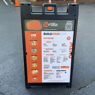 a menu on a sign in a parking lot
