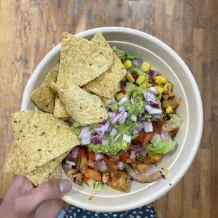 a person holding a bowl of food