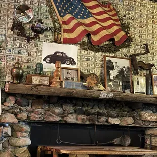 Old fireplace and dollar bills on the walls