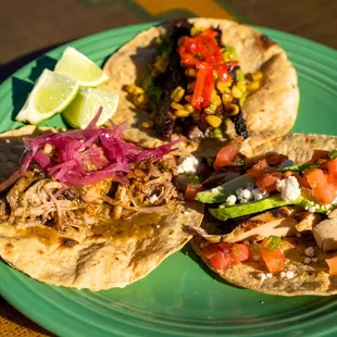 three tacos on a green plate