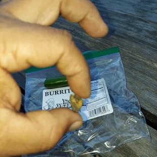 a hand holding a burrito