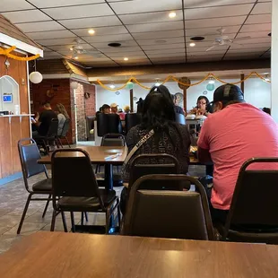 people sitting at tables in a restaurant