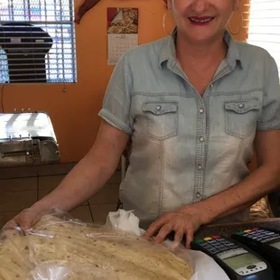 a woman preparing tortillas