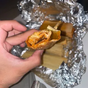 a hand holding a sandwich