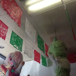 two stuffed animals hanging from the ceiling