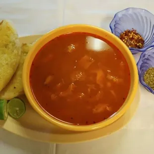 a bowl of tortilla soup with bread