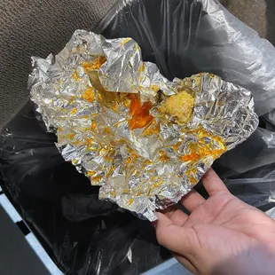 a hand holding a piece of foil