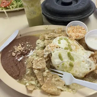 Eggs, chips and refried beans, corn tortillas and salsa verde