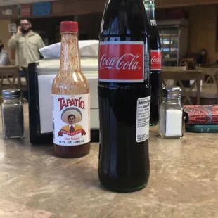 a bottle of tortilleria and a bottle of sauce