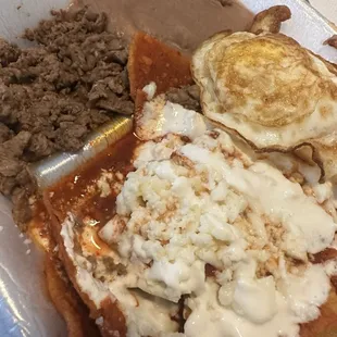 Chilaquiles with a side beans and carne asada