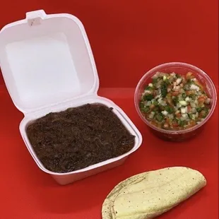 a burrito and a bowl of salsa