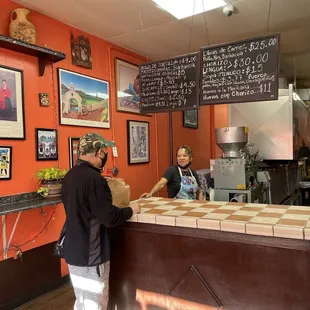 two people standing at the counter