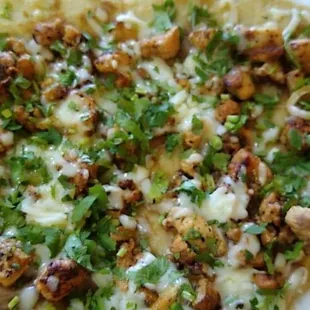 a tortilla topped with meat and cheese
