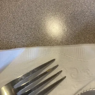 Dirty fork with dried beans on it from previous person