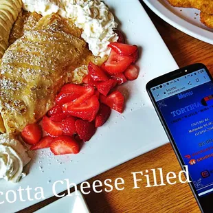 a plate of food and a cell phone