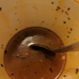 a spoon in a bowl of melted chocolate