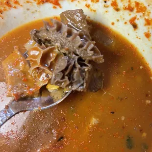 Dark over heated honey comb menudo meat.