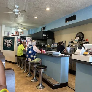 Bar area with the best waitress serving up some good coffee .